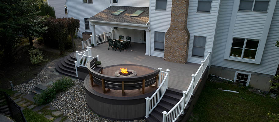 Custom backyard deck with white railings and fire pit seating — Triple A Decking Bismarck Mandan ND